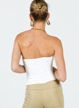 Strapless corset Sweetheart neckline Inner silicone strip at bust Button fastening at front Boing throughout Split hem 