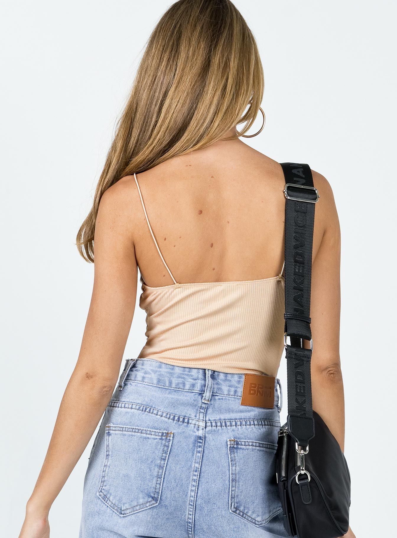 back view of model wearing Princess Polly Dex Bodysuit Beige Sleeveless Plunger 