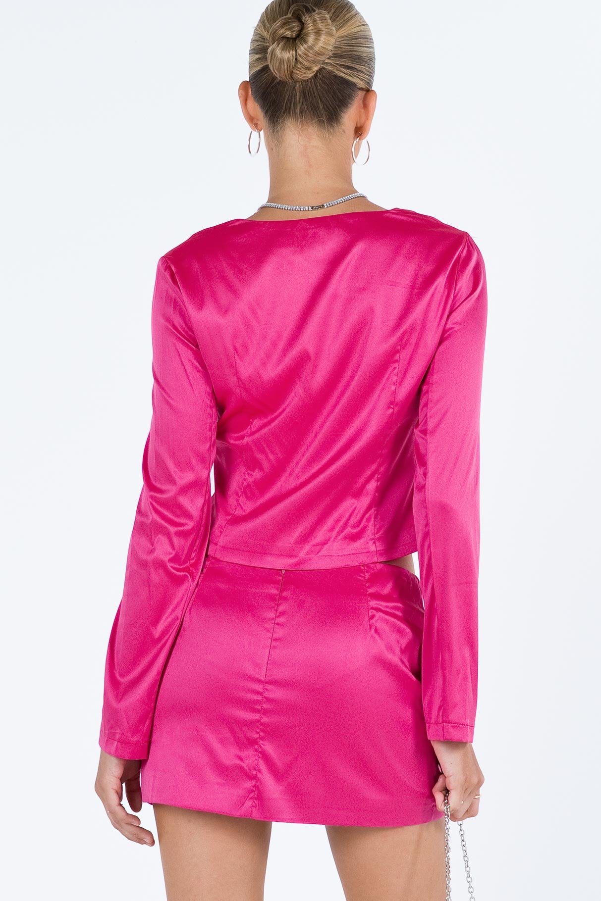 Pink matching set Silky material Long sleeve top V neckline Hook and eye fastening at bust Split hem Mini skirt Invisible zip fastening at back