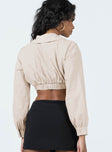 Long sleeve top Classic collar  Button front fastening  Cropped design  Elasticated waistband at back  Single button cuff 