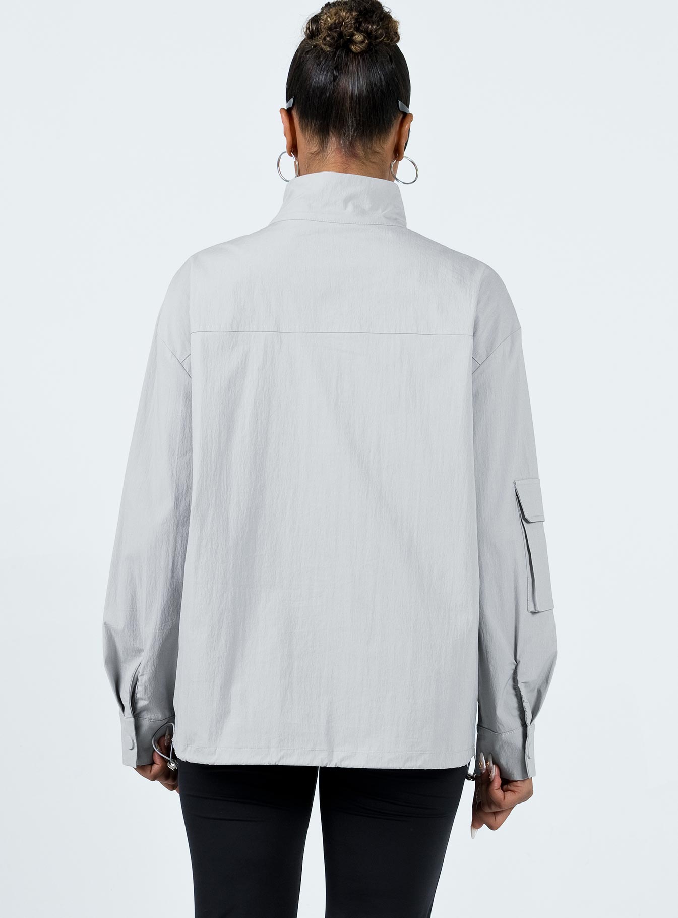 Jacket Windbreaker material High neck Zip front fastening Cargo style pocket on right sleeve Twin front pockets Press studs at cuff Drawstring hem