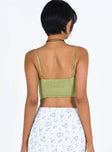 Green crop top Silky material Adjustable shoulder straps Scooped neckline Shirred band at back Pointed hem
