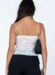 Top Sheer lace material  Elasticated shoulder straps  Raw cut hem 