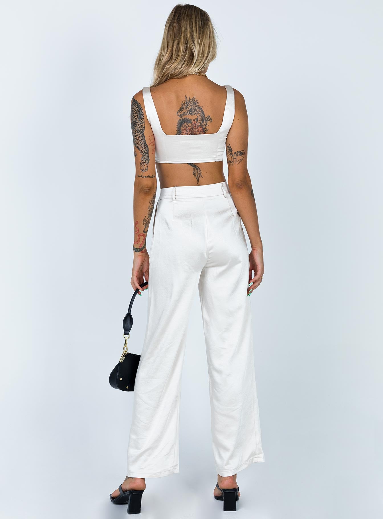 Matching set Soft silky material Crop top Fixed straps Invisible zip fasting at side High waisted pants Wide relaxed leg Belt loops at waist Zip & button fastening Lined top