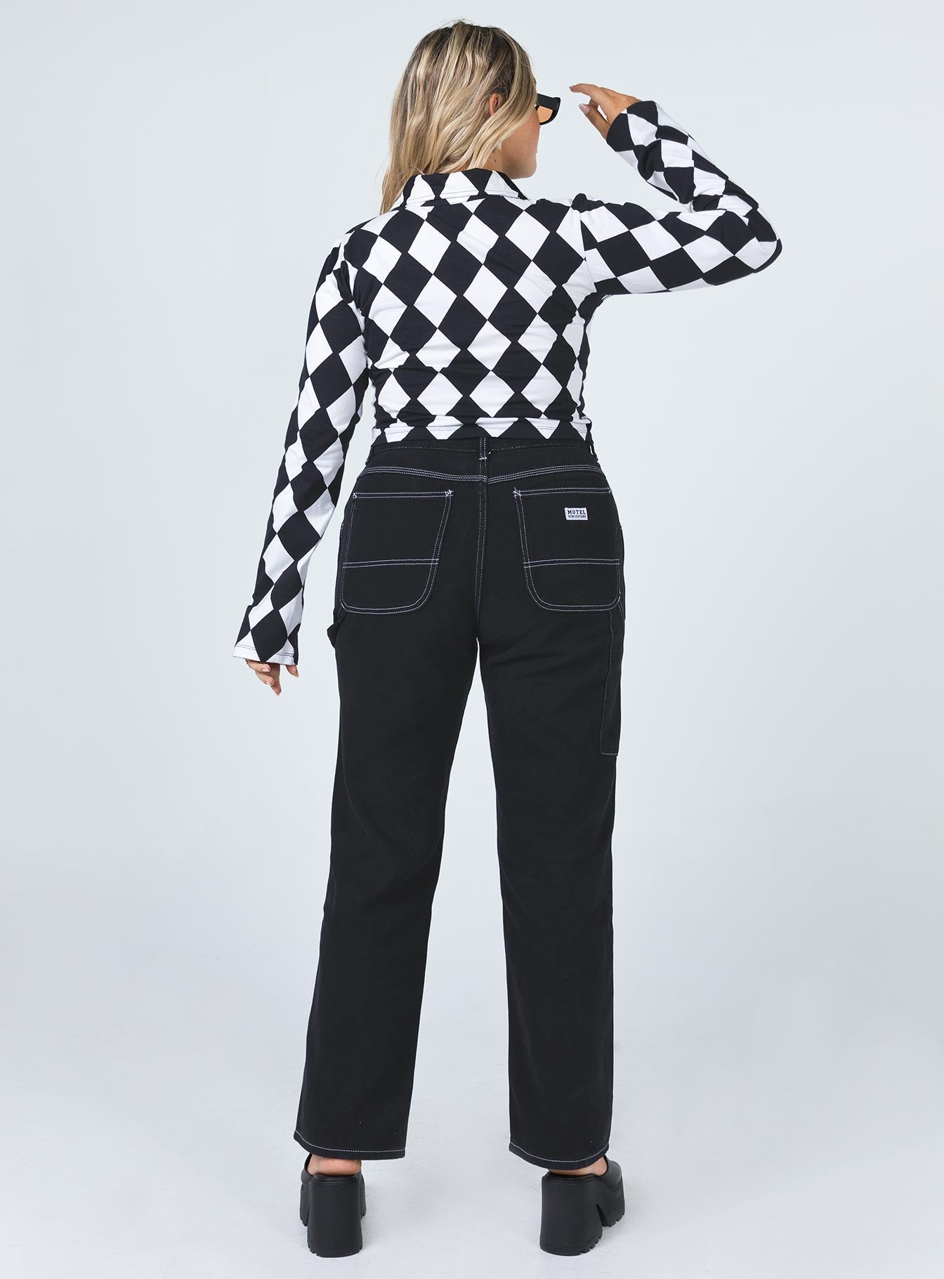 back view of model wearing Princess Polly Motel Carpenter Jeans Black Mid Rise 