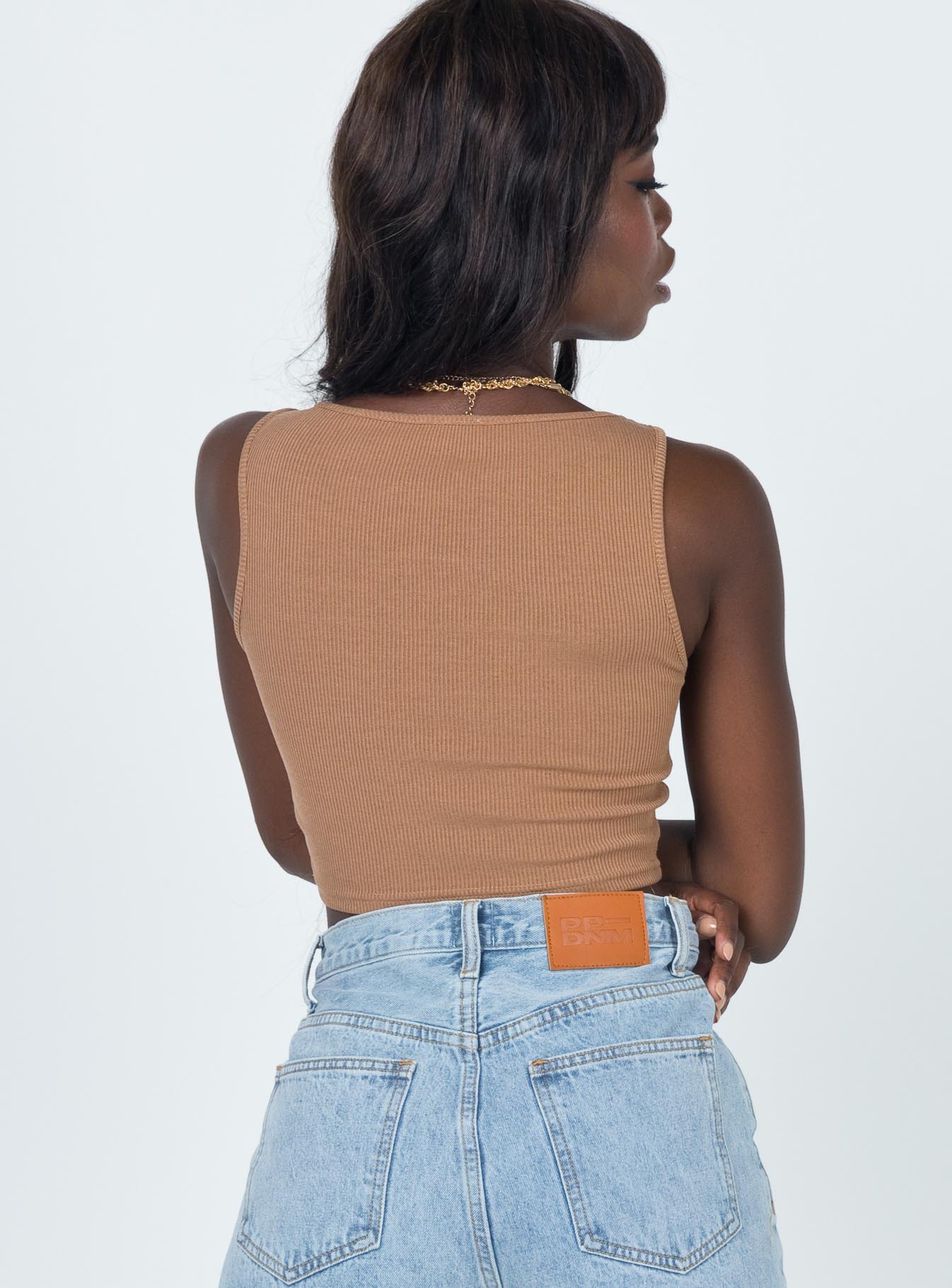 Front view of model wearing  front Princess Polly Sleeveless Square Neck  Darlington Crop Top Brown