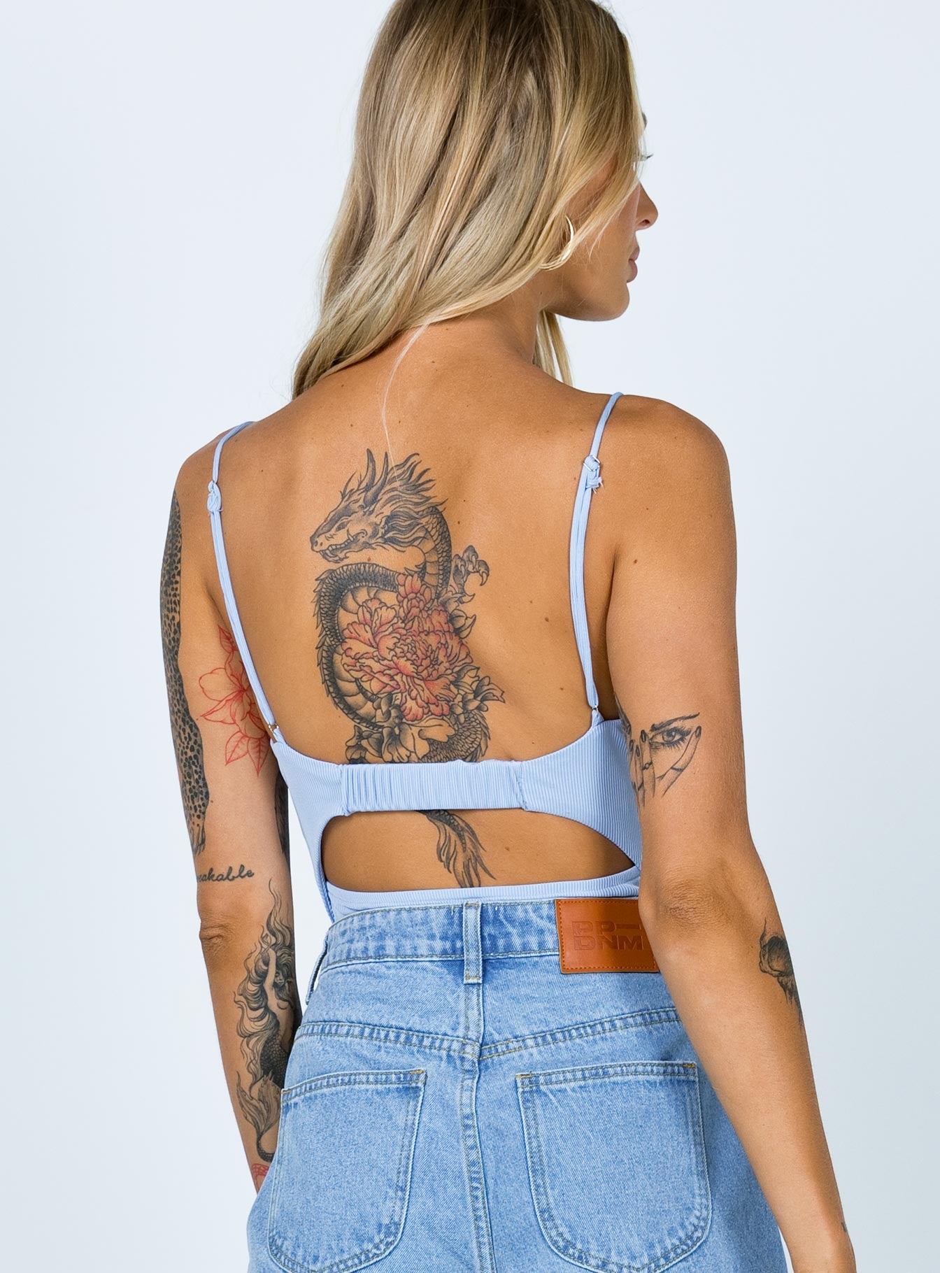 back view of model wearing Princess Polly Bow Bodysuit Blue Sleeveless Plunger 