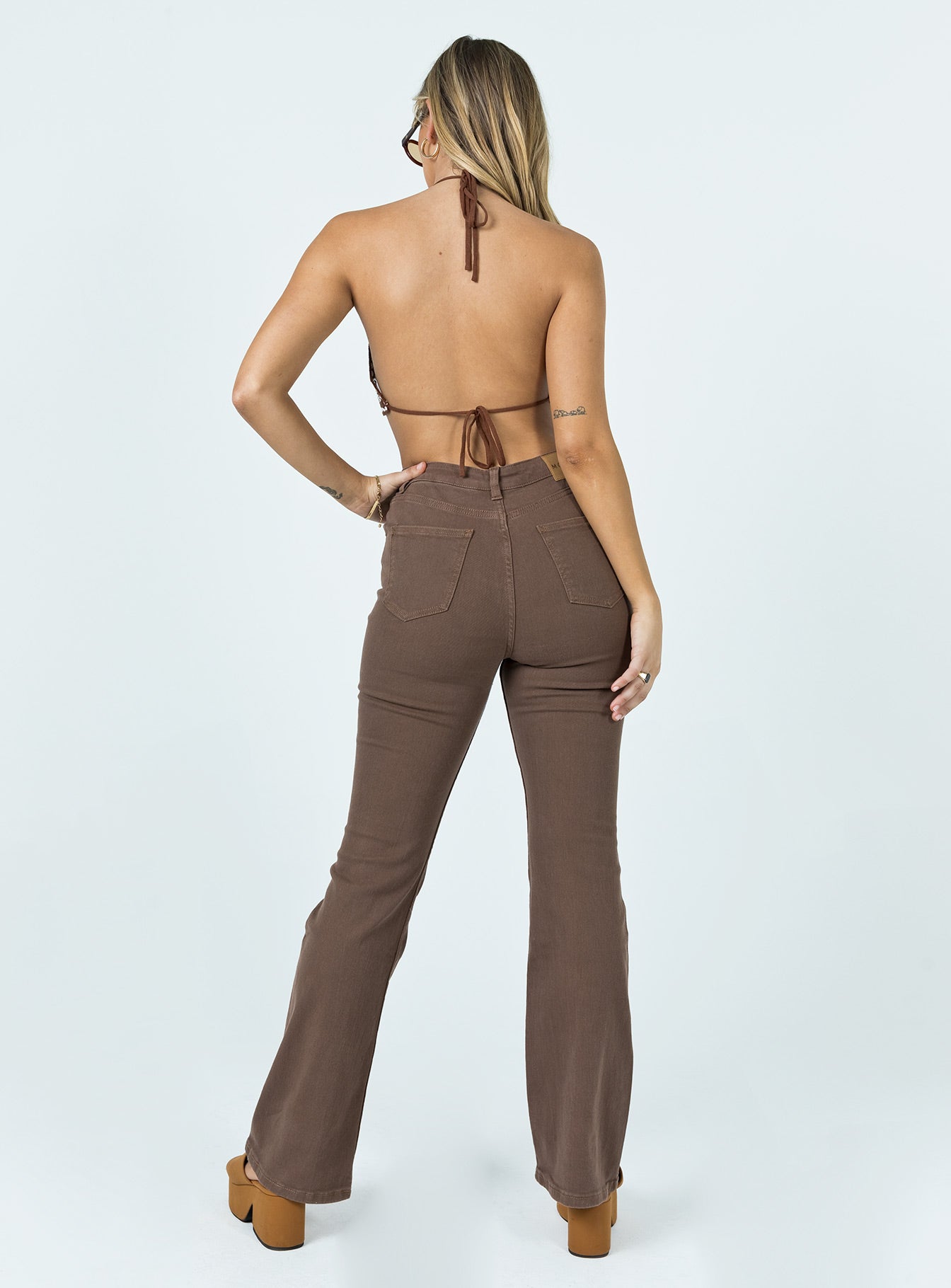back view of model wearing Princess Polly Motel Bootleg Jeans Rich Brown High Waisted 