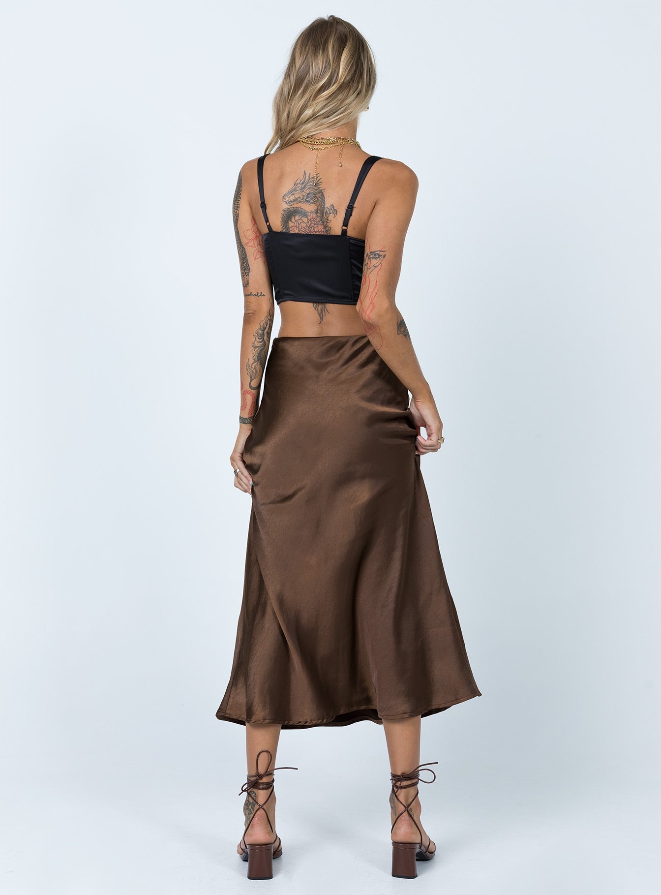 back view of model wearing Princess Polly Tyra Satin Midi Skirt Brown 