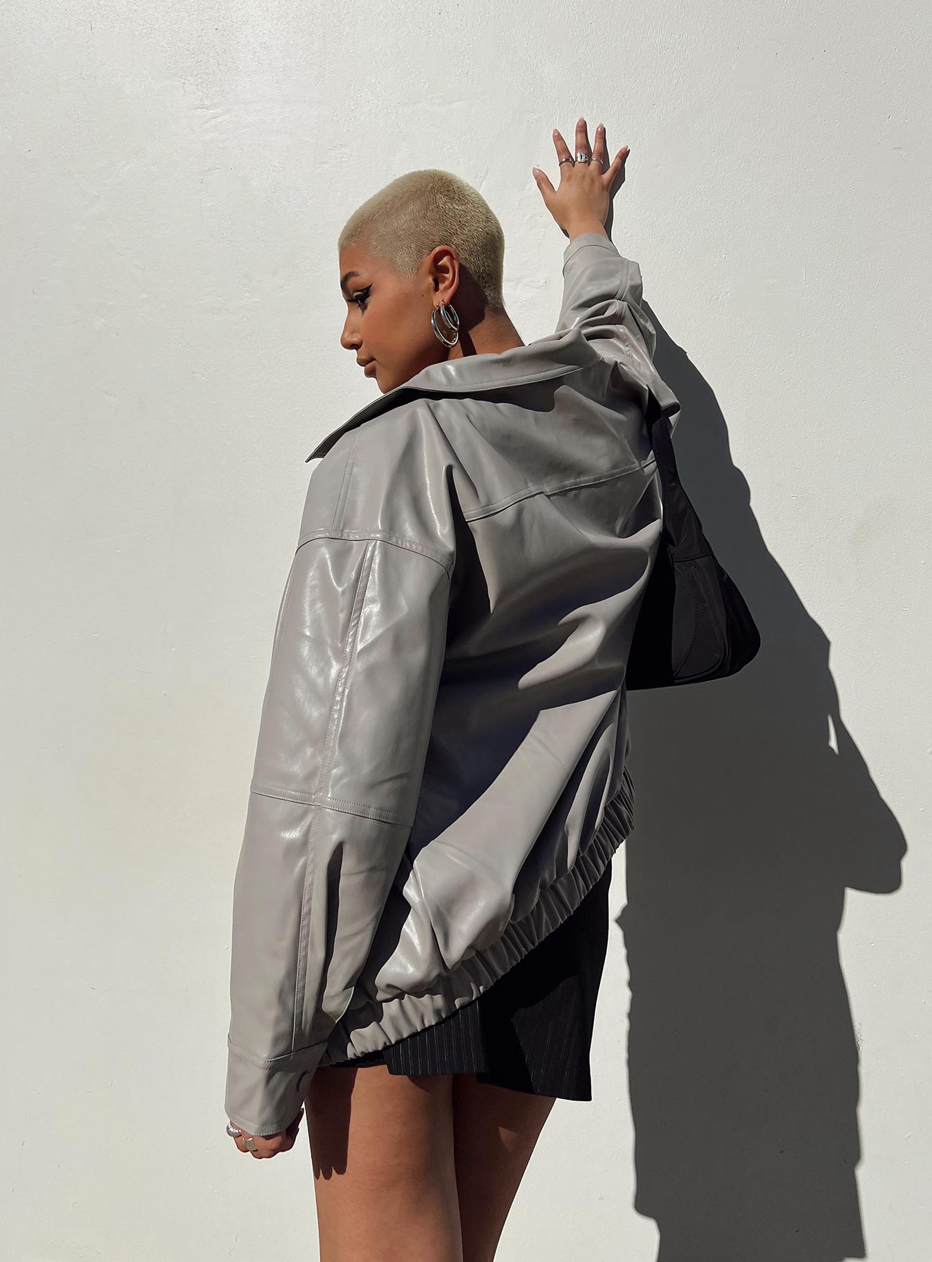 Grey bomber jacket Faux leather material Pointed collar Zip front fastening Twin hip pockets Elasticated waistband