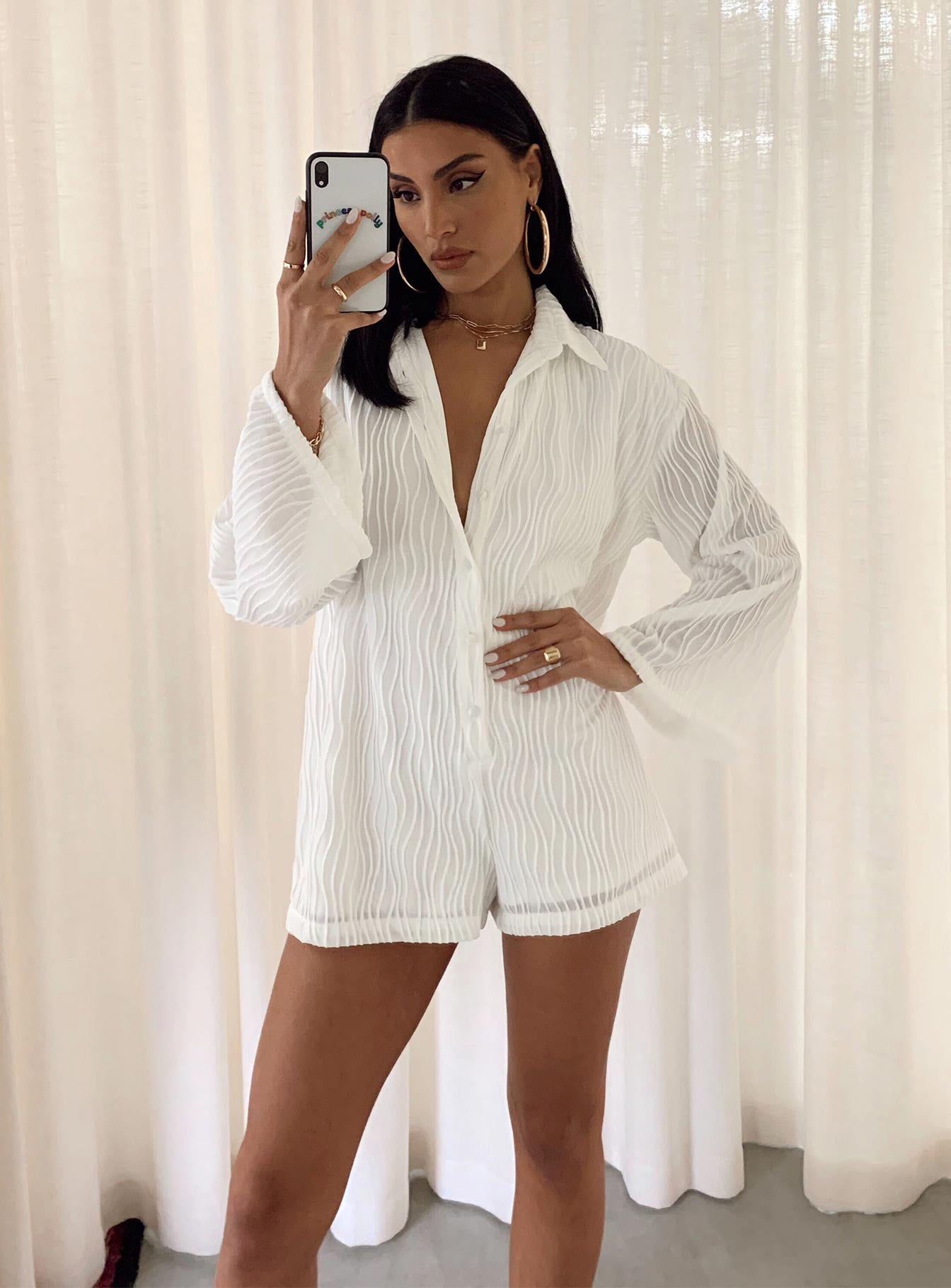 Long sleeve romper Textured material  Button front fastening  Wide sleeves 