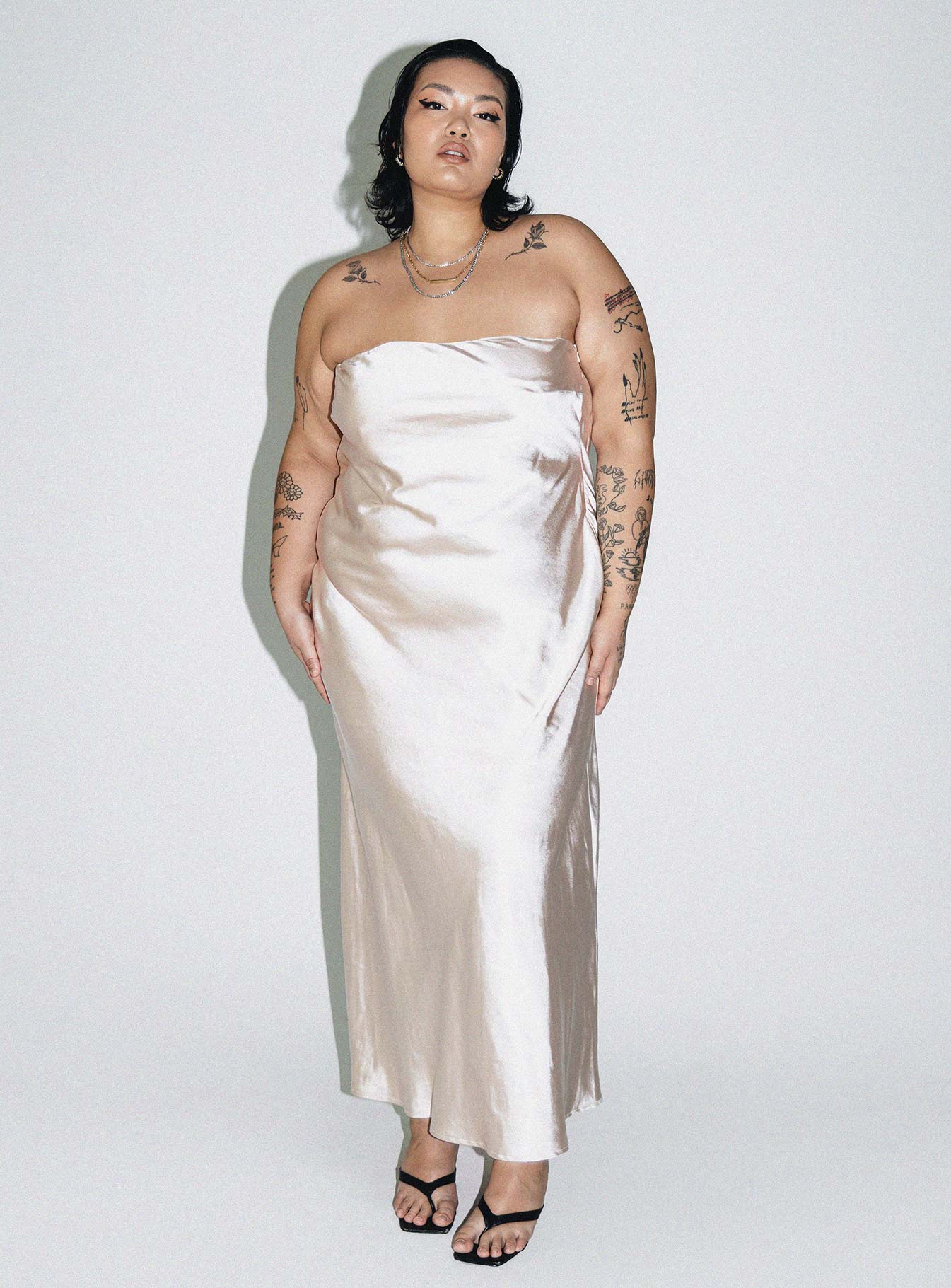Front view of model wearing  front Princess Polly Asymmetric Neckline  Haley Maxi Dress Champagne Curve