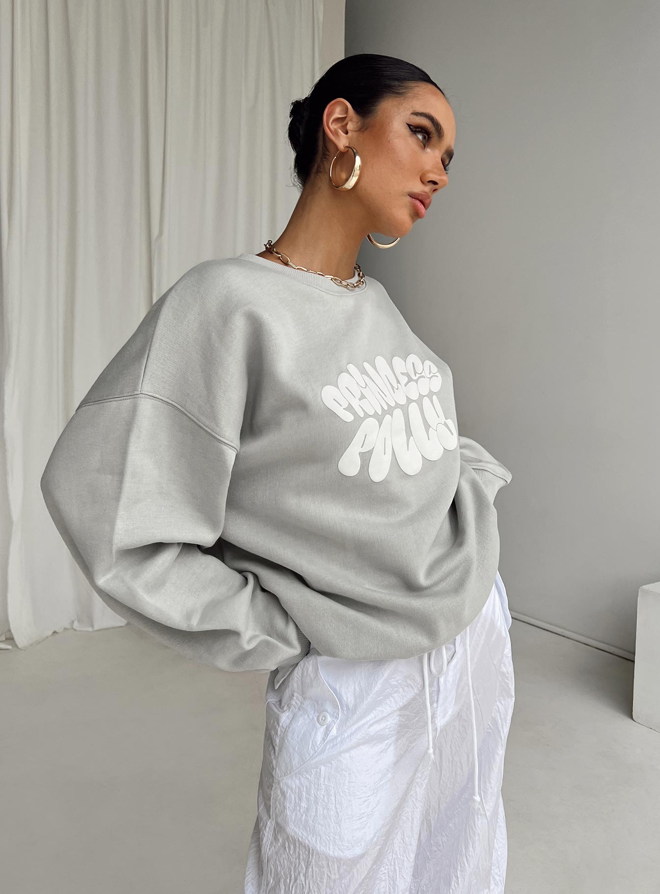 side view of model wearing Princess Polly Princess Polly Crew Neck Sweatshirt Bubble Text Grey / Cloud White Long 