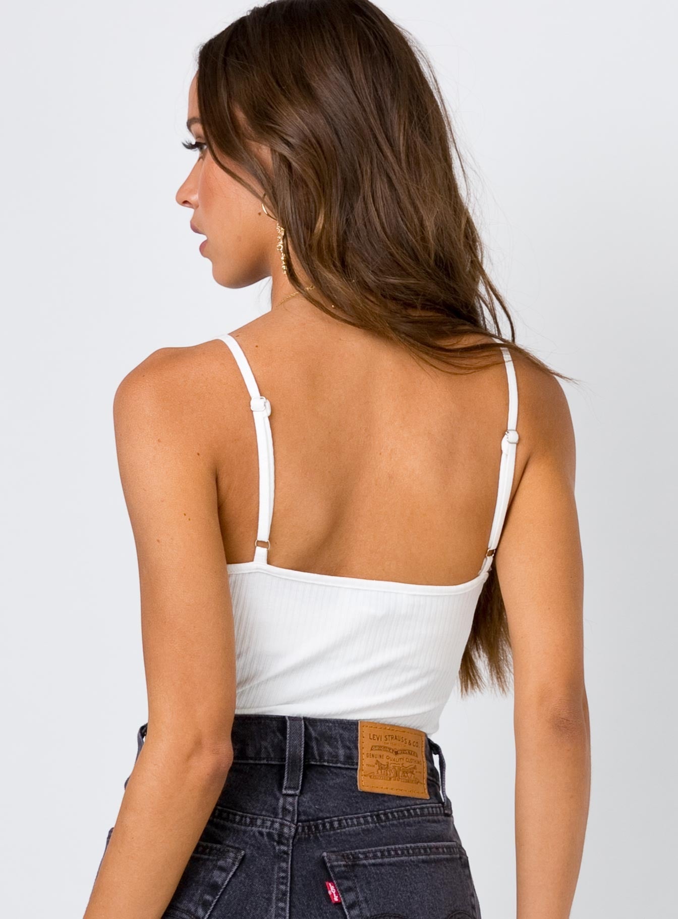 back view of model wearing Princess Polly Sumba Bodysuit White Sleeveless Plunger 