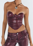 Bustier Faux leather material Inner silicone strip at bust Wired cups Zip fastening at back Pleats at side Pointed hem