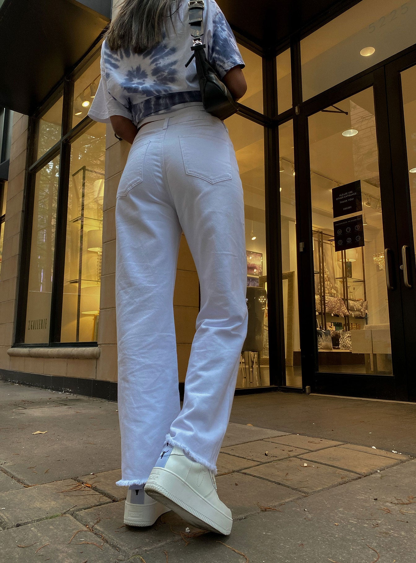 back view of model wearing Princess Polly Cece Hammer Wide Leg Knee Rip Jeans White Denim Mid Rise 