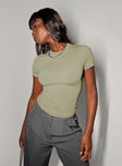 Front view of model wearing  front Princess Polly Short Sleeves High Neck  Lowell Top Green