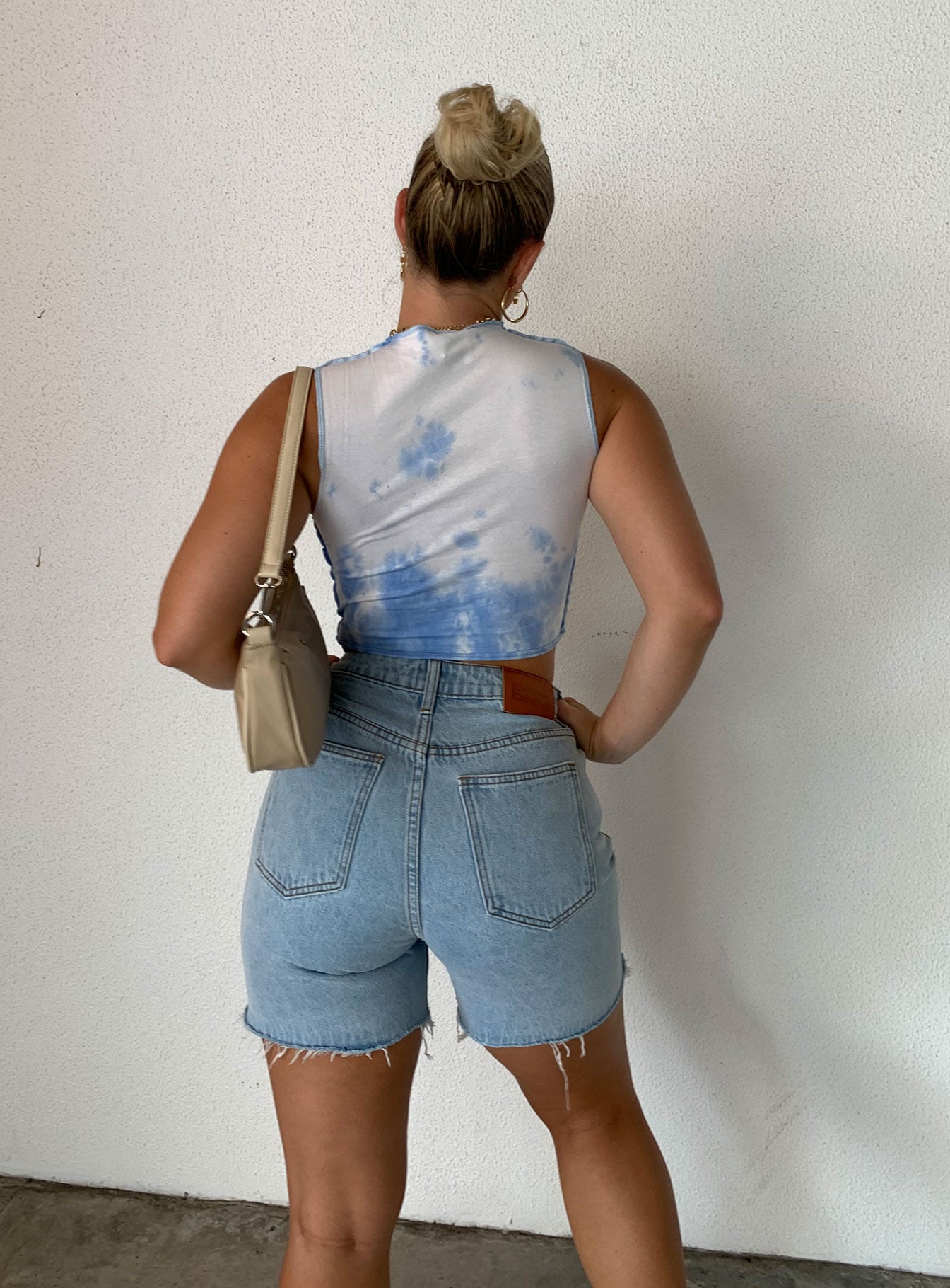 back view of model wearing Princess Polly Maggie Denim Shorts Denim High Waisted Shorts 