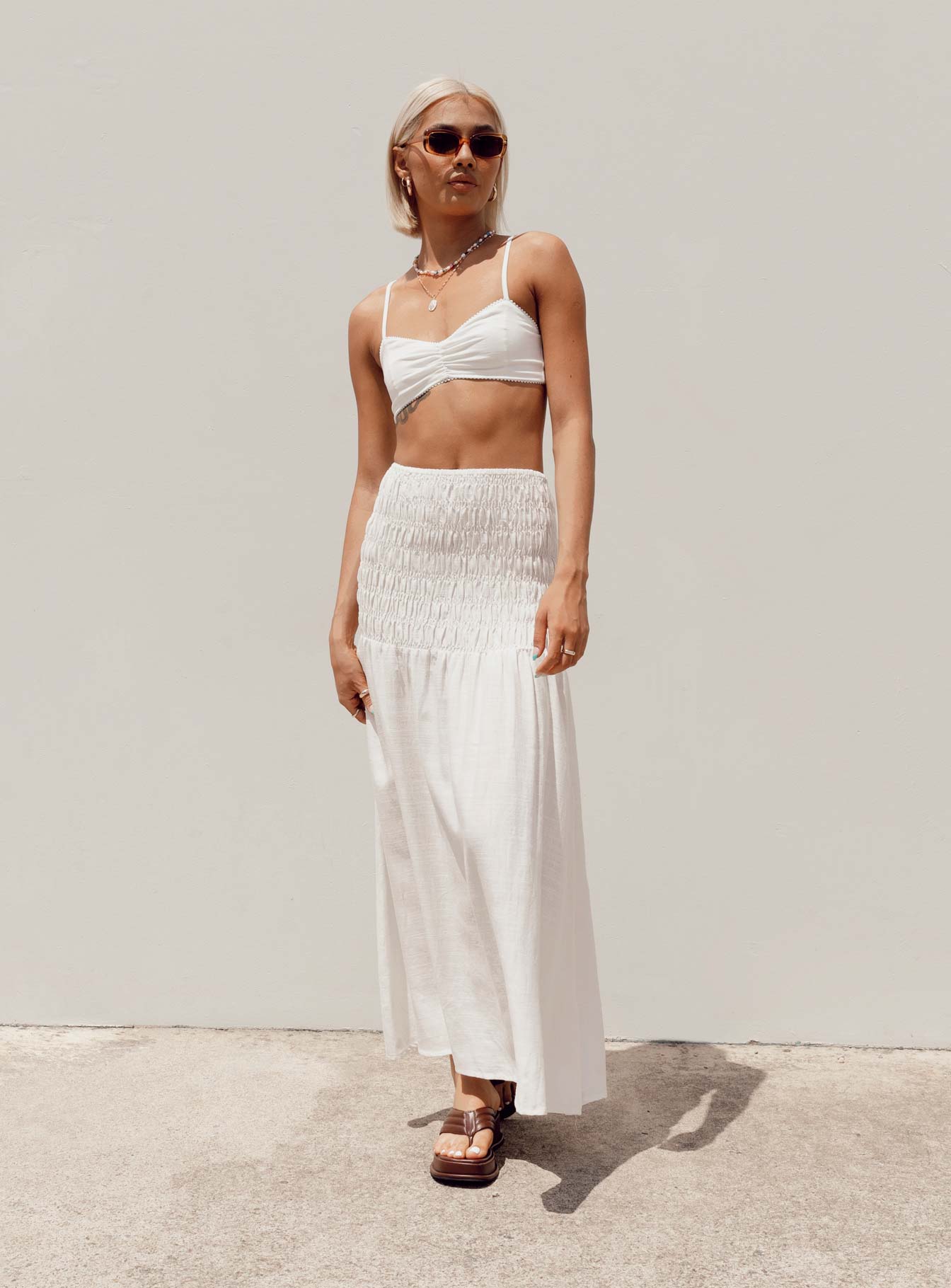   side view of model wearing Princess Polly Porto Maxi Skirt White Maxi 
