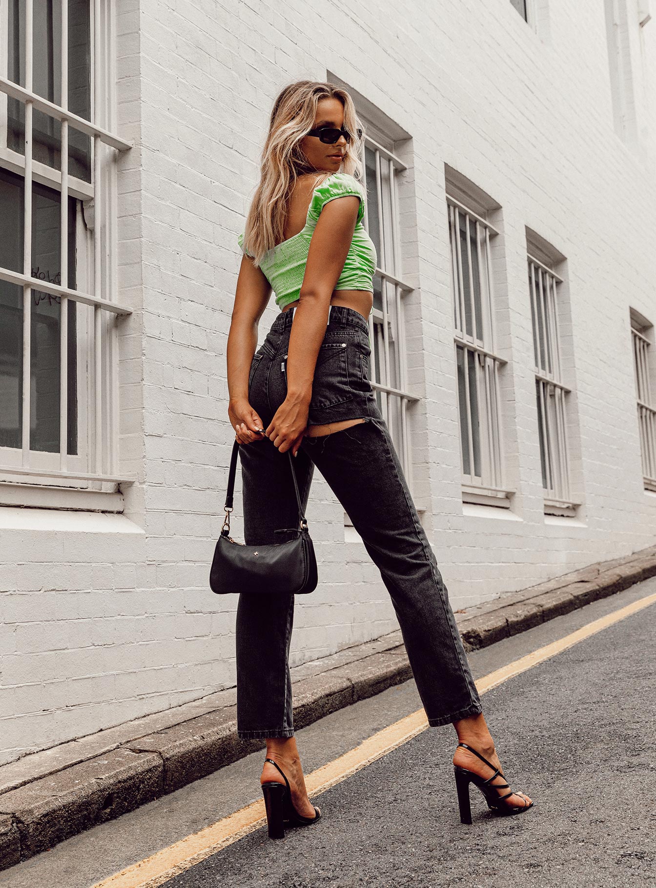 side view of model wearing Princess Polly Ragged Priest Butt Cut Jean Mid Rise 