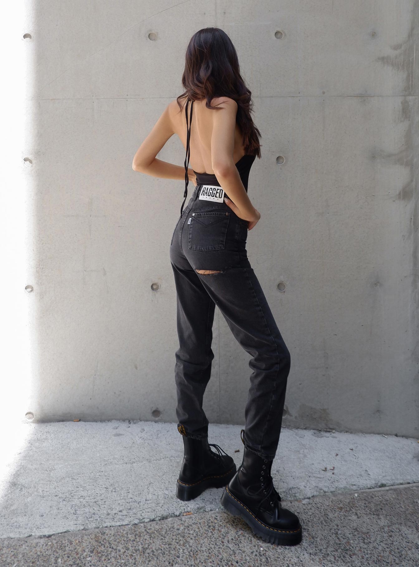 back view of model wearing Princess Polly Ragged Priest Butt Cut Jean Mid Rise 