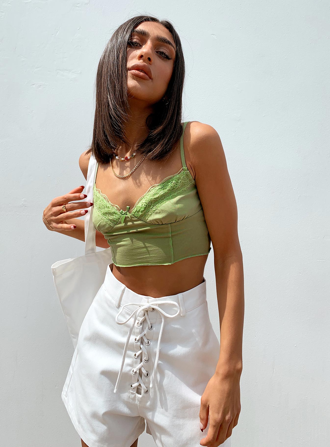 side view of model wearing Princess Polly Simple Things Crop Top Green 